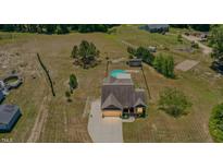 Expansive lot with pool, outbuilding, and charming home with mature trees and lawn at 187 Old Johnson Rd, Wendell, NC 27591