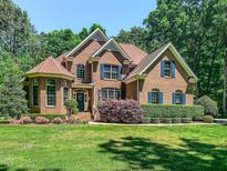 Beautiful brick home with manicured lawn and blue shutters at 19 Rivers Edge Ct, Timberlake, NC 27583