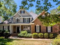 Charming two-story home featuring a welcoming front porch and a well-manicured lawn at 2405 Flints Pond Cir, Apex, NC 27523