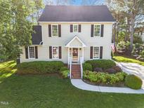 Charming two-story home with a well-manicured lawn and lush landscaping enhancing its curb appeal at 3204 Terrel Mill Rd, Raleigh, NC 27616