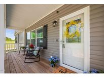 Charming front porch with rocking chairs, seasonal decor, and a welcoming entrance at 380 Perdues Rd, Louisburg, NC 27549