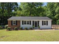 Charming single-story home featuring a combination of brick and white siding and a well-maintained front lawn at 430 Fenton St, Raleigh, NC 27604