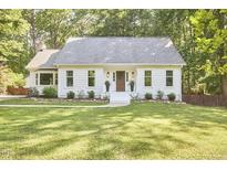 Charming single-story home with a well-manicured lawn and inviting front entrance at 5642 Falkirk Dr, Durham, NC 27712