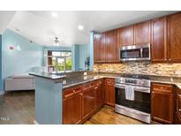 Modern kitchen features stainless steel appliances, granite counters, and stylish backsplash at 618 N Boylan Ave # 622, Raleigh, NC 27603
