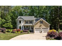 Charming two-story home featuring a two-car garage and lush landscaping at 624 Moultonboro Ave, Wake Forest, NC 27587