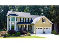 Charming two-story home featuring a two-car garage, manicured landscaping and a welcoming front porch at 624 Moultonboro Ave, Wake Forest, NC 27587
