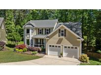 Charming two-story home with attached two-car garage, manicured lawn, and mature trees at 624 Moultonboro Ave, Wake Forest, NC 27587
