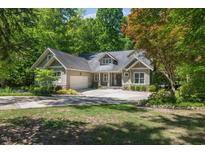 Charming home with a well-manicured lawn, attached garage, and beautiful landscaping at 6509 Mountain Brook Ln, Raleigh, NC 27615