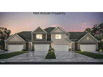 Charming duplex featuring a two-car garage, stone accents, and a well-maintained lawn at 710 Blackpool Dr, Durham, NC 27703