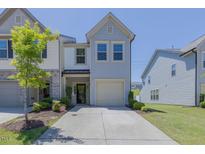 Charming two-story home with a well-manicured lawn and attached garage in a residential neighborhood at 79 Hawkstone Dr, Clayton, NC 27527