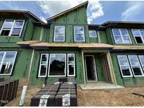Modern home exterior featuring large windows and a contemporary design, showcasing its curb appeal at 803 Fireship Rd, Fuquay Varina, NC 27526