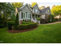 Charming two-story home with manicured lawn and lush landscaping at 945 Jones Wynd, Wake Forest, NC 27587