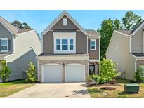 Charming two-story home featuring a two-car garage and beautifully landscaped front yard at 1021 Sweet Cream Ct, Durham, NC 27703