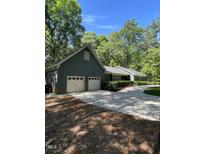 Charming home with a two-car garage and well-maintained landscaping at 10505 Winding Wood Trail Trl, Raleigh, NC 27613
