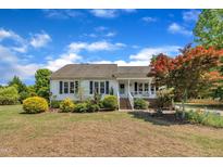 Charming single-story home with well-manicured landscaping and a welcoming front porch at 1112 Turner Farms Rd, Garner, NC 27529
