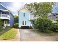Charming two-story home with a well-maintained front yard and a concrete driveway at 117 Idlewild Ave, Raleigh, NC 27601