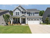 Charming two-story home with a well-manicured lawn, beautiful landscaping and a two car garage at 121 Woodstaff Ave, Wake Forest, NC 27587