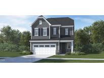 Two-story home with gray siding, a two-car garage, and a well-manicured lawn at 136 Fairport Ln, Apex, NC 27539