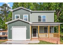 Charming two-story home featuring a covered porch and a single-car garage at 1408 South St, Durham, NC 27707