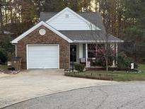 Charming single-story home featuring a brick facade, attached garage, and well-manicured landscaping at 1454-17 Cimarron Pkwy, Wake Forest, NC 27587