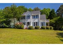 Charming two-story home with landscaped yard and beautiful curb appeal on a sunny day at 2 Great Oak Ct, Durham, NC 27713