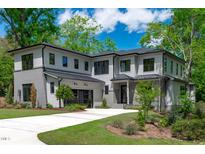 Stunning two-story home boasts a modern design, professional landscaping, and attached garage at 2104 Manuel St, Raleigh, NC 27612