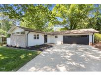 Charming renovated home with stone accents, attached garage and a well-manicured front yard with mature trees at 2505 Catalina Ct, Raleigh, NC 27607