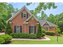 Charming traditional brick home with lush landscaping and a well-manicured lawn at 27 Woodgate Ct, Durham, NC 27713