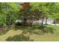 Charming single-Gathering home with a well-manicured lawn and mature trees at 306 N Sixth St, Mebane, NC 27302