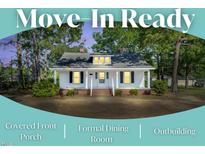 Charming single story home with a covered front porch, a brick staircase, and mature trees at 310 Chicopee Rd, Benson, NC 27504