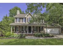 Charming traditional home with mature trees and a well-manicured front lawn at 3204 Peachford Ln, Raleigh, NC 27616