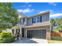 Charming two-story home boasts a brick and siding exterior, complemented by a well-manicured lawn and a two-car garage at 3801 Althorp Dr, Raleigh, NC 27616
