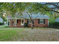 Charming brick home with mature trees and well-maintained front yard at 418 S 2Nd St, Smithfield, NC 27577