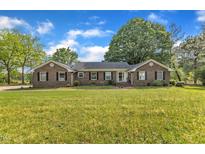 Charming brick home featuring a spacious front yard and manicured landscaping at 4314 Hopkins Rd, Middlesex, NC 27557