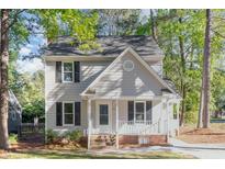 Charming two-story home featuring a covered porch and a well-maintained front yard at 4621 Worthington Ln, Raleigh, NC 27604