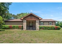 Charming single-story home featuring a stone entrance and lush landscaping at 620 Mcghees Mill Rd, Roxboro, NC 27574
