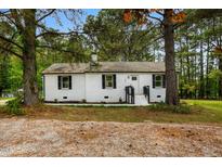 Charming brick home with black shutters, a black front door, and landscaped front yard at 109 Riverbend Dr, Archer Lodge, NC 27527