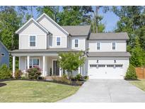 Charming two-story home featuring a two-car garage and a beautifully landscaped front yard at 1102 Birchbark Rd, Durham, NC 27705