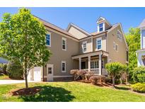 Charming two-story home with a well-manicured lawn, a covered front porch, and attached garage at 113 Ruskin Dr, Chapel Hill, NC 27516
