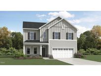 Charming two-story home showcasing light gray siding, black shutters, and an attached two-car garage at 1556 Bright Coral Trl, Wendell, NC 27591