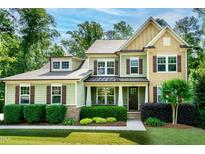 Charming two-story home featuring a well-manicured lawn and inviting curb appeal with lush landscaping at 1820 Yates Wheel Way, Raleigh, NC 27606