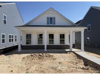 New construction home with brick facade and a charming front porch featuring classic white columns at 2874 Quarry Rd # 165, Rolesville, NC 27571