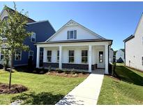 Charming single-story home with a welcoming front porch, manicured lawn, and attractive landscaping at 2874 Quarry Rd # 165, Rolesville, NC 27571