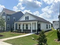 Charming single-story home with a welcoming front porch and beautifully landscaped yard at 2874 Quarry Rd # 165, Rolesville, NC 27571