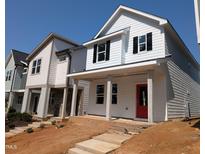 Charming new construction home with white siding, black shutters, and a vibrant red front door at 332 Cottage Hl, Knightdale, NC 27604