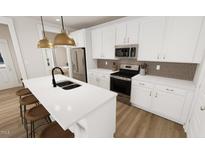 Modern kitchen with stainless steel appliances, center island, and stylish countertops at 332 Cottage Hl, Knightdale, NC 27604