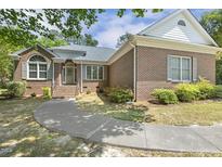 Charming brick home with a curved walkway and well-maintained landscaping at 3404 Apple Meadow Dr, Fuquay Varina, NC 27526