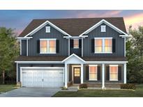 Charming two-story home featuring a welcoming front porch, attached garage, and professionally landscaped front yard at 353 Bridle Brook Way, Fuquay Varina, NC 27526