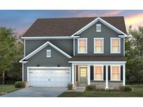 Charming two-story home with gray siding, white trim, a two-car garage, and a welcoming front porch at 428 Providence Springs Ln, Fuquay Varina, NC 27526