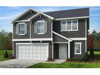 Charming two-story home with a well-manicured lawn and a two-car garage at 701 Kerry Cattle Dr, Rolesville, NC 27571